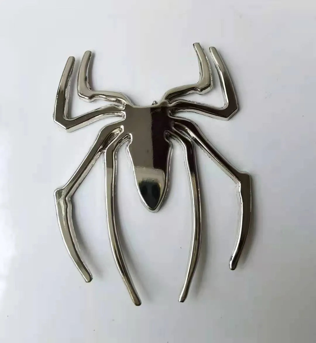 Zinc alloy 3D spider bumper sticker in metallic colours on a car bumper.