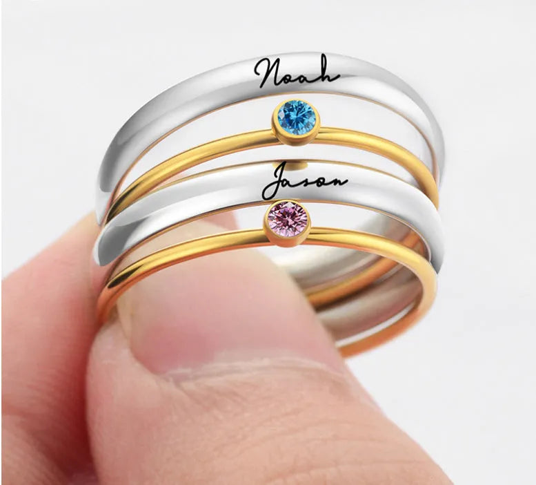 Gold geometric engraved titanium steel ring with a superimposed dark blue December birthstone.