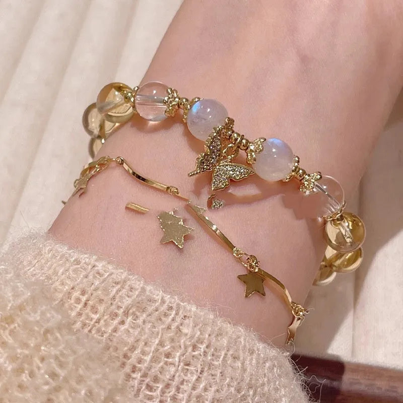 Moonstone white crystal beaded bracelet with citrine butterfly charm on display