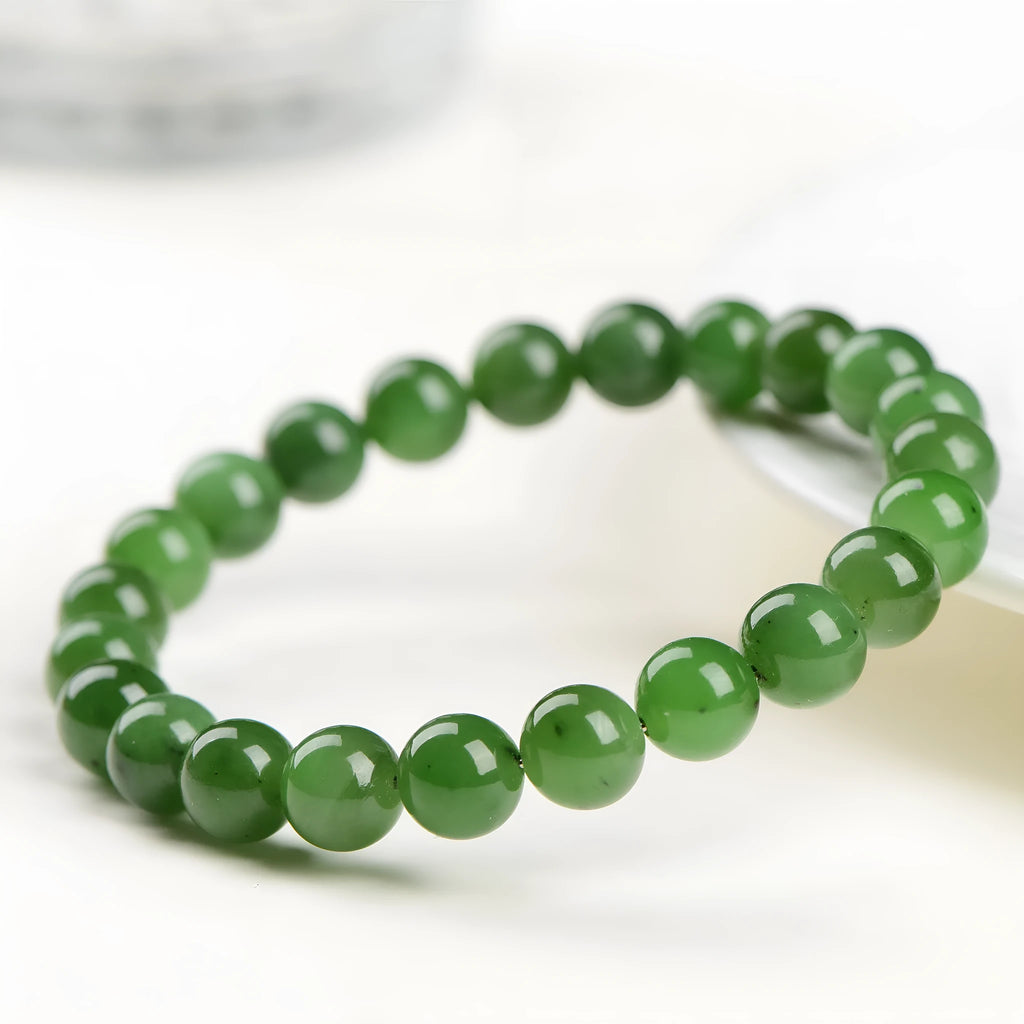 Natural Hetian jade and jasper bead bracelet showing polished spherical beads on a wrist.
