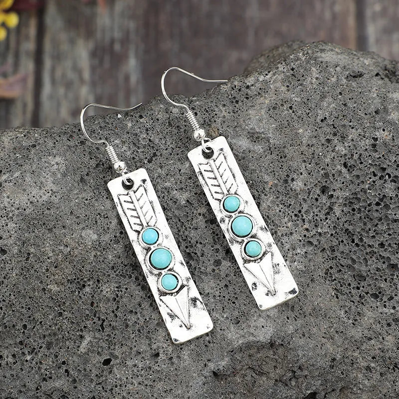 Silver geometric long drop earrings with turquoise inlay on a retro-style zinc alloy setting.