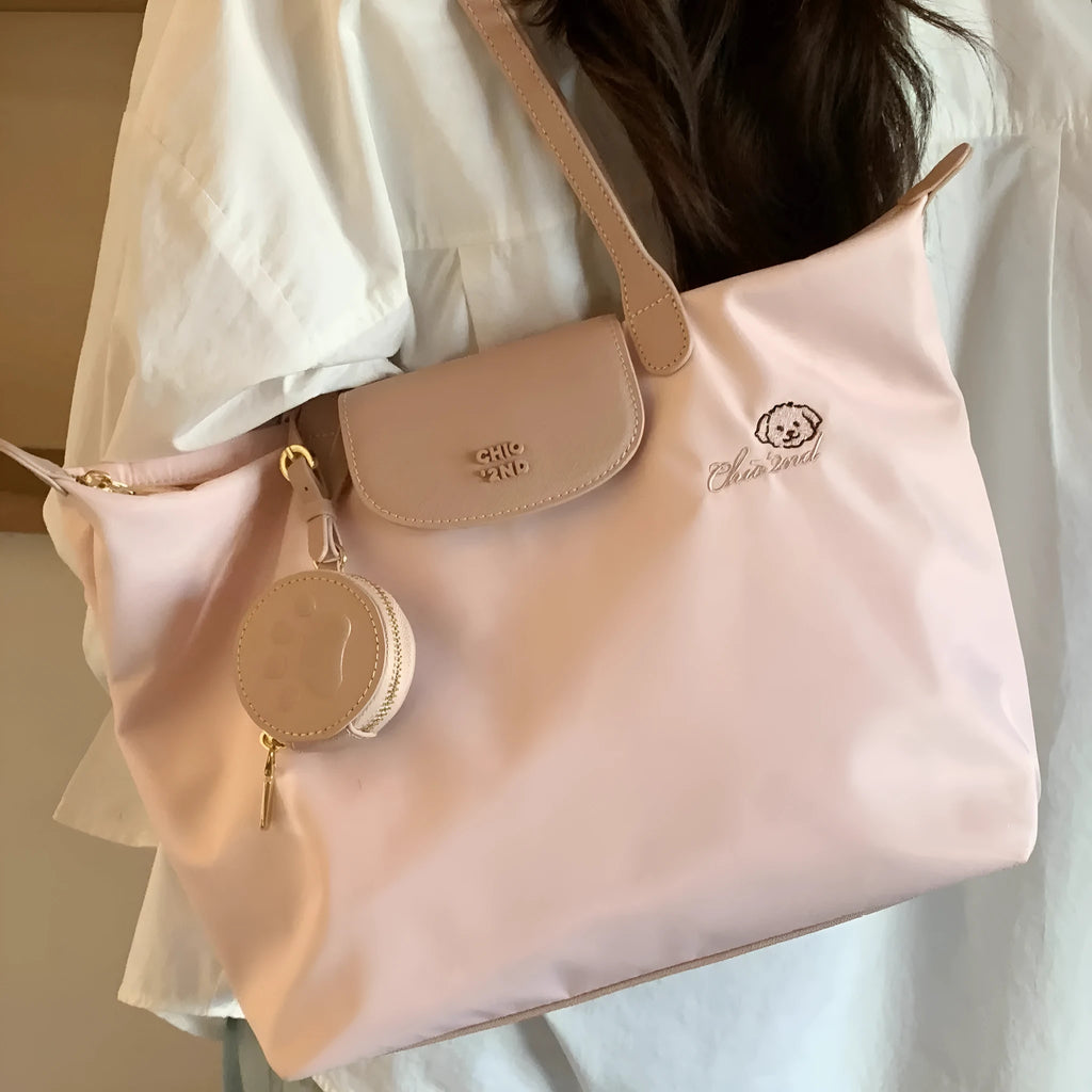 Pink Oxford cloth large tote shoulder bag with a structured square shape and a shoulder strap.