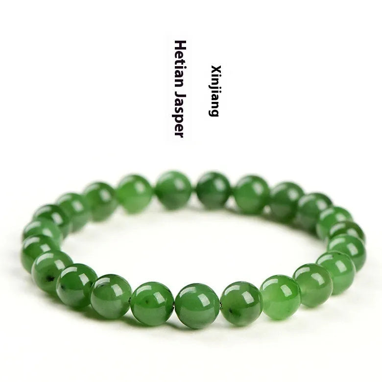 Natural Hetian jade and jasper bead bracelet showing polished spherical beads on a wrist.