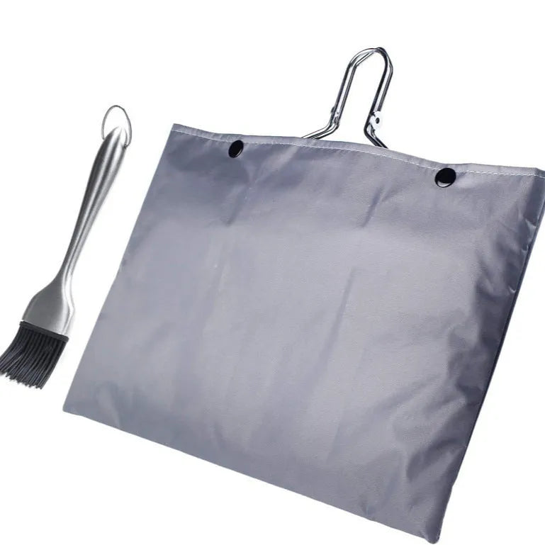 Square stainless steel barbecue mesh basket in a folded position next to a cleaning brush.