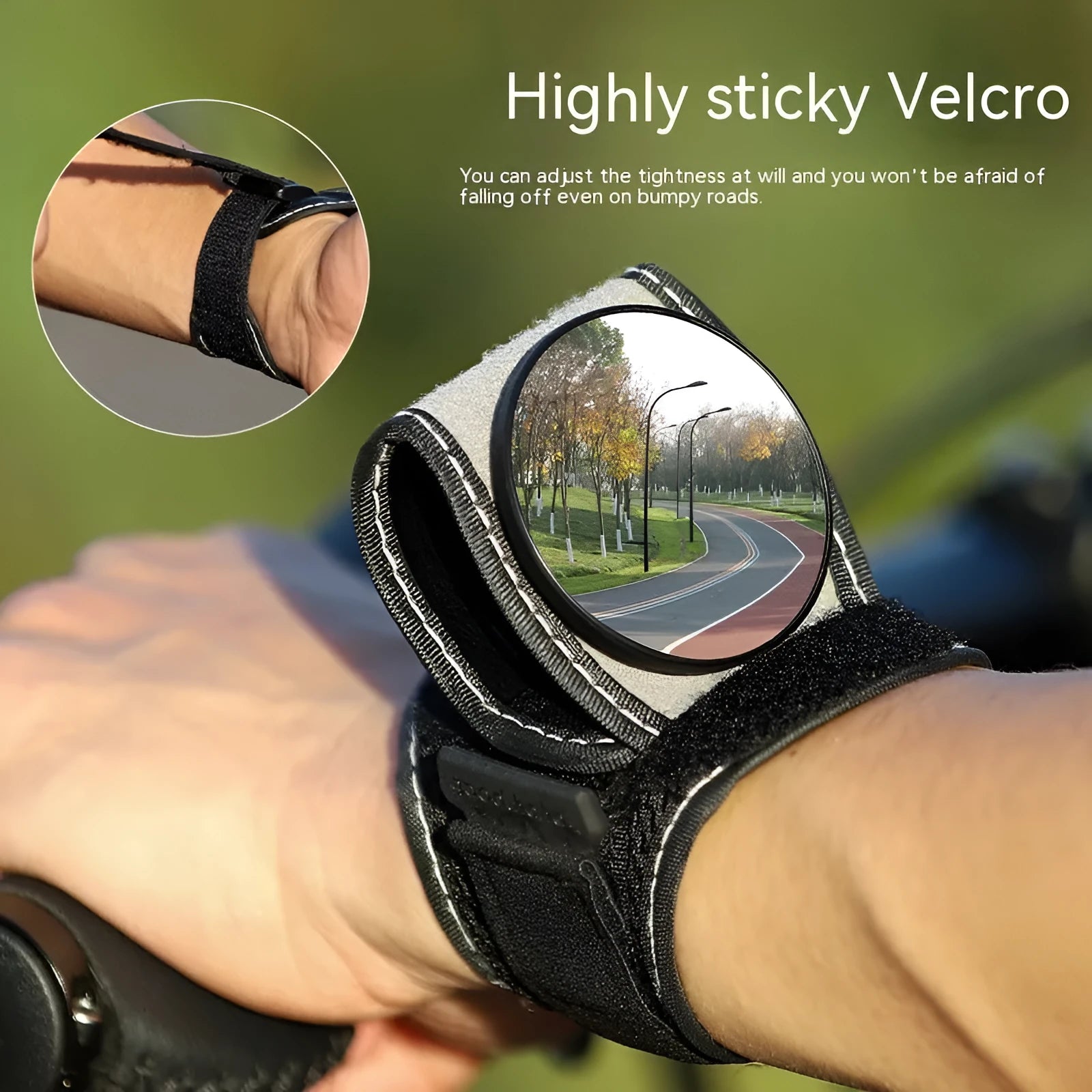 Black nylon wrist-mounted bicycle rear-view mirror shown on a cyclist's wrist.