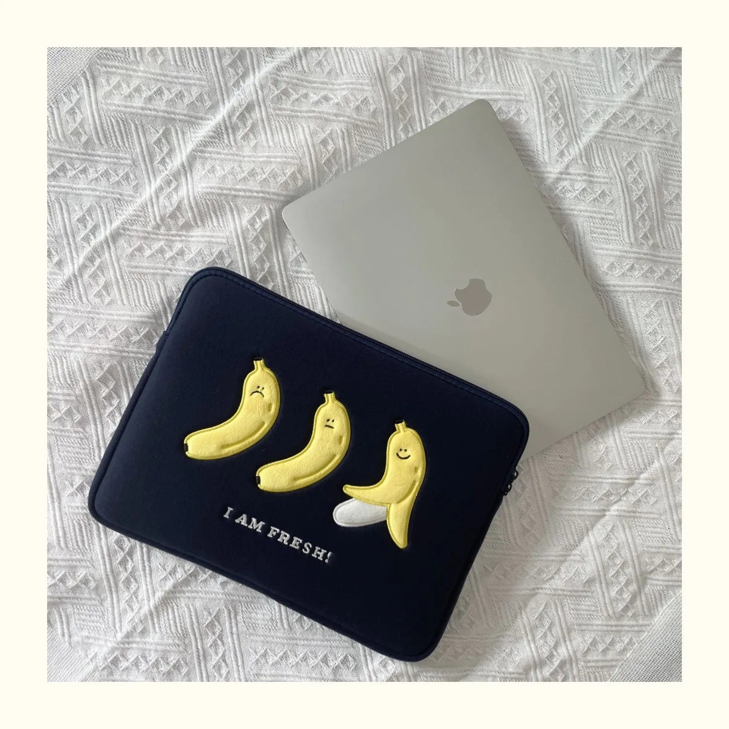 Embroidered laptop sleeve with animal design showing polyester construction and size options