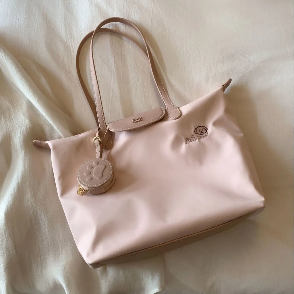 Pink Oxford cloth large tote shoulder bag with a structured square shape and a shoulder strap.