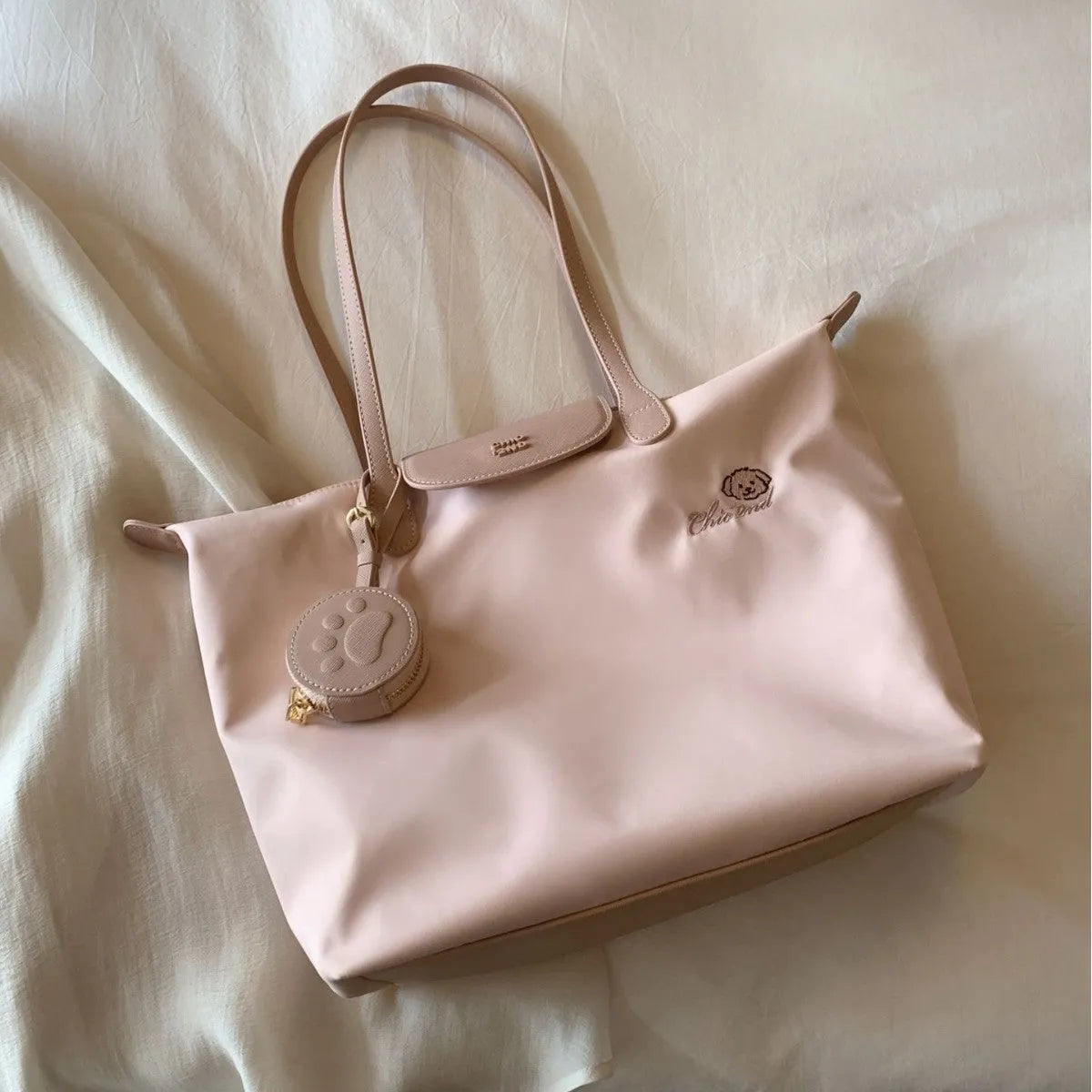 Pink Oxford cloth large tote shoulder bag with a structured square shape and a shoulder strap.