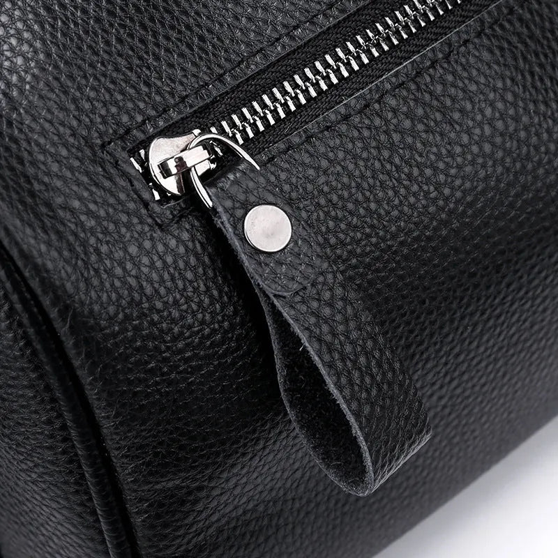 Black genuine leather one-shoulder crossbody bag showing front and strap.