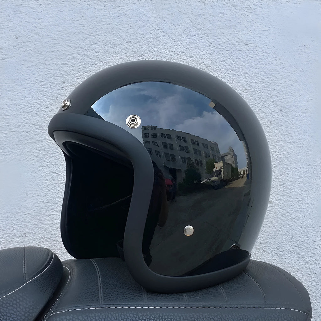 Retro-style open-face motorcycle helmet in glass fibre construction shown in a cement grey colour.