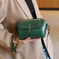 Women's brown shell-shaped messenger bag in oil wax leather with cross-body strap and organised interior