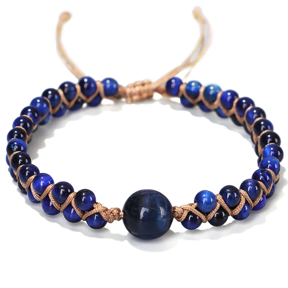 Handmade woven geometric pull bracelet with blue Tigereye stone beads on a wrist.