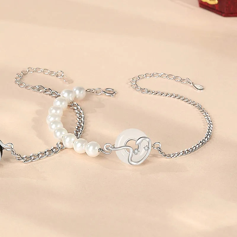 A New Chinese style 925 sterling silver couple bracelet with an obsidian pearl and snake zodiac motif on a secure buckle.