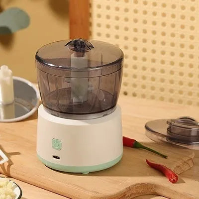 Mini meat grinder with white body, transparent 225ml cup, and anti-slip base on a kitchen countertop