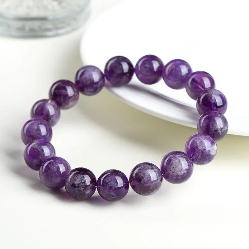 Natural feather amethyst crystal bracelet in Snow Mountain purple with scattered beads and Ruyi element.