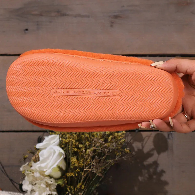 Orange plush-lined indoor slippers with non-slip PVC soles and coral velvet upper