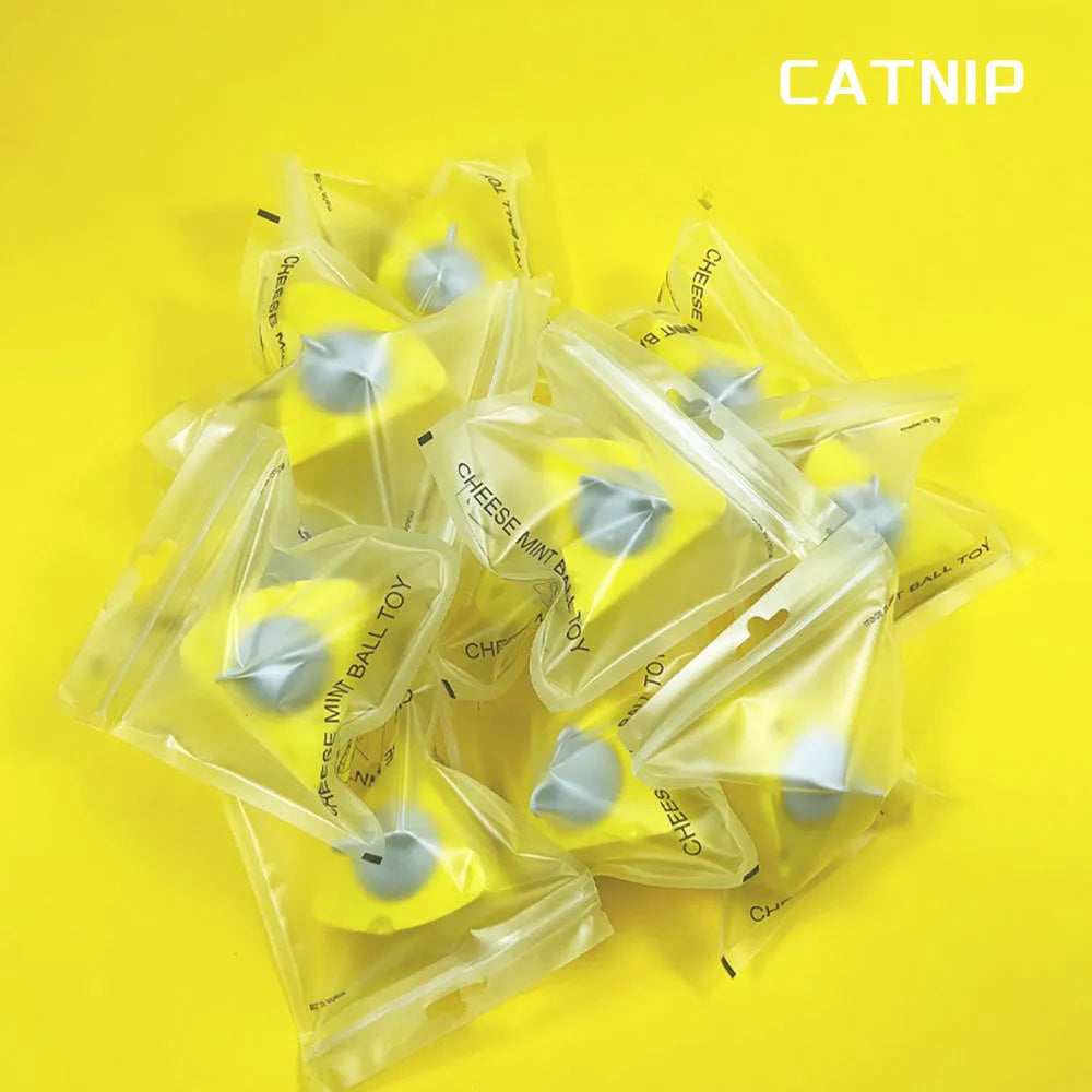 Yellow catnip and silvervine chew ball toy for cats on wooden floor