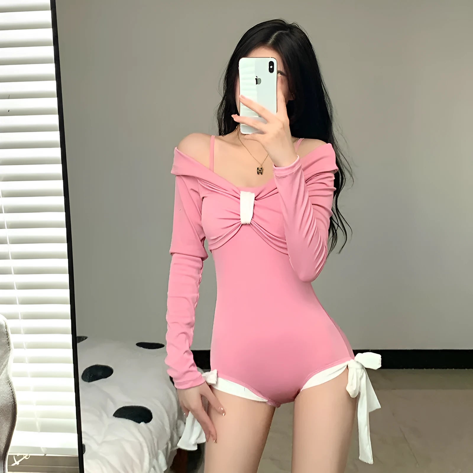 Women's long sleeve one-piece swimsuit in pink and black, showing front and back views.