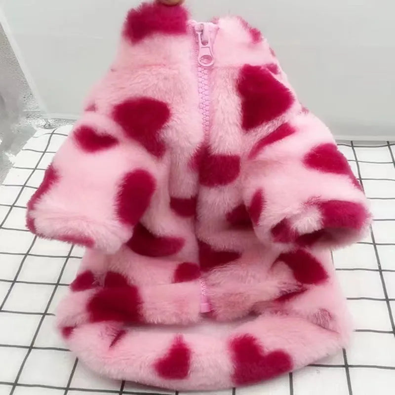 Small dog wearing a plush pink warm coat for cold weather protection