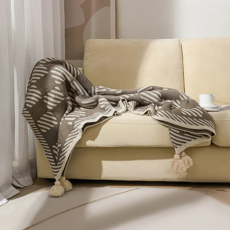Bohemian style acrylic sofa throw blanket with tassel trim in a geometric pattern colour