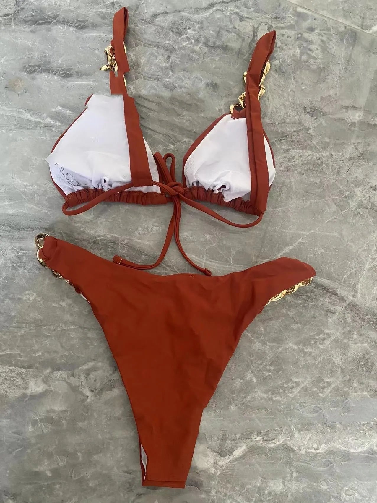 Brown women's bikini swimsuit with tube-top ring tether design and split high-cut legs