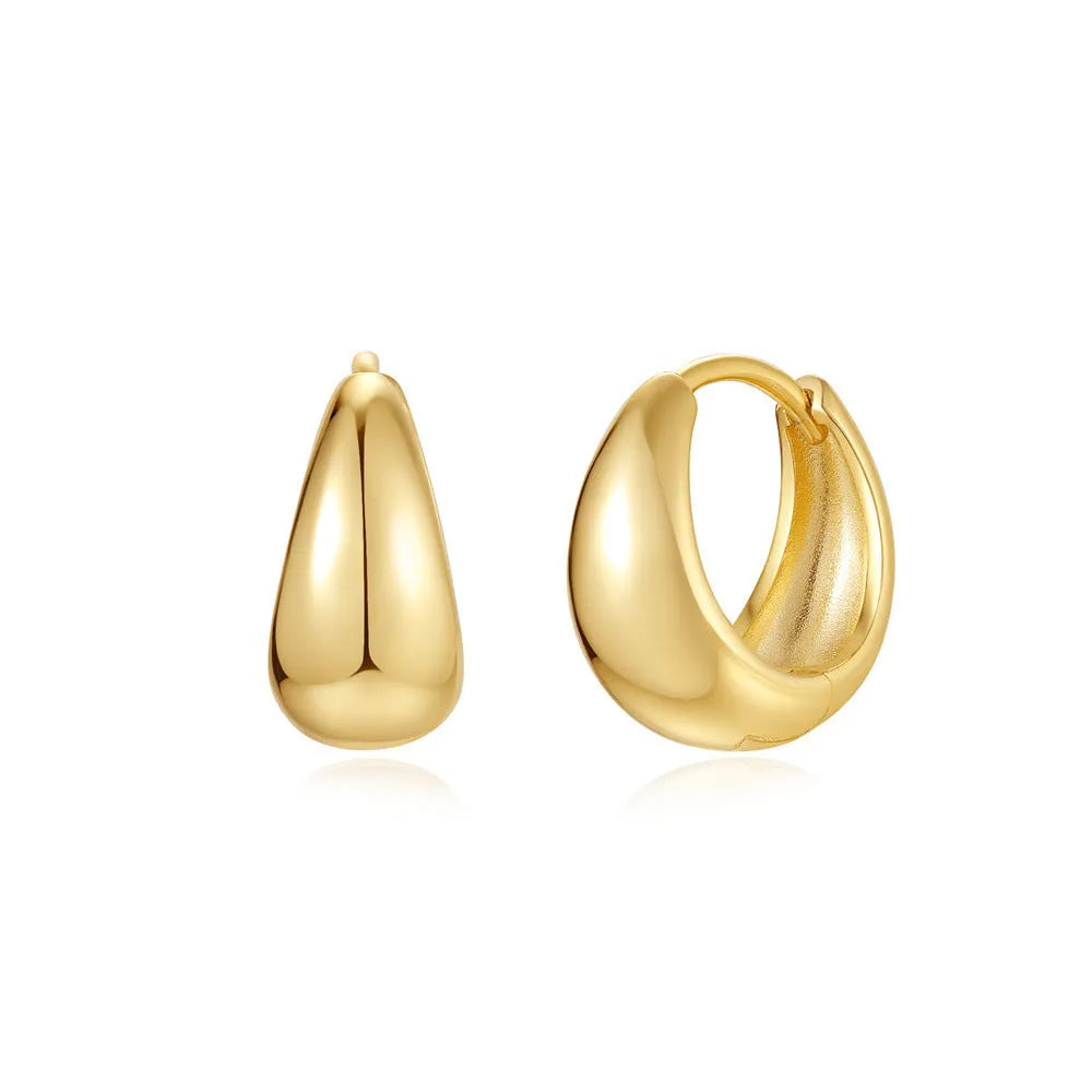 A pair of round, geometric brass earclip earrings with a gold electroplated finish.