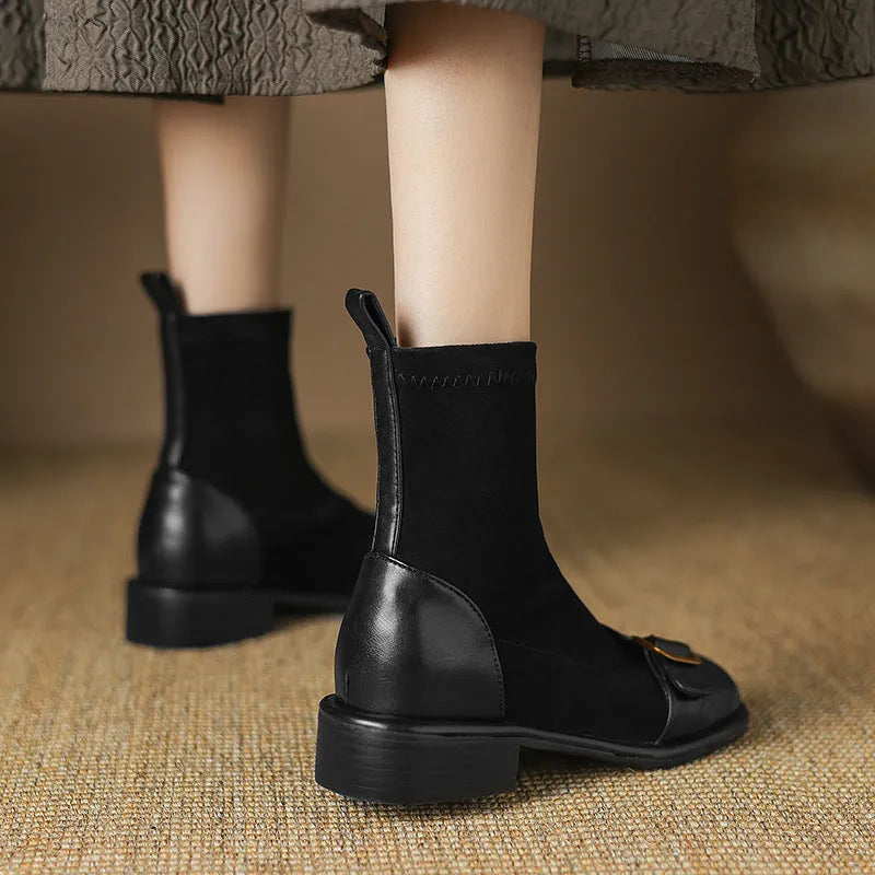 Women's black low heel Martin ankle boots with belt buckle stitching and lace-up front.