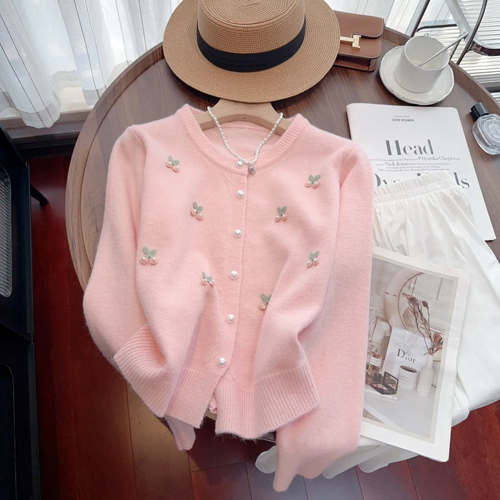 Cashmere blend slim fit cardigan sweater coat with beaded decoration on a hanger.