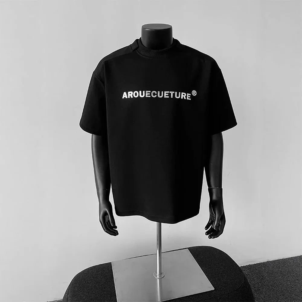 Men's short sleeve cotton shirt in loose pullover style available in black, white, and light grey