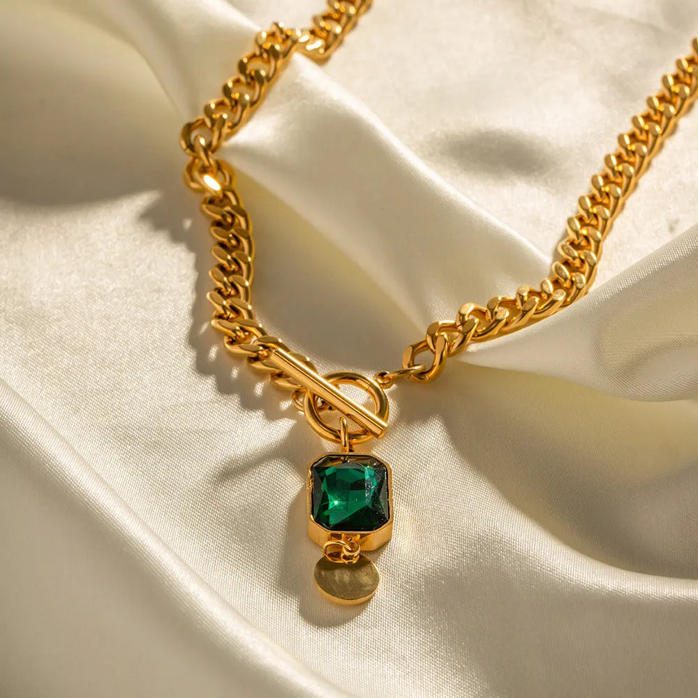 Gold electroplated titanium steel necklace with geometric round emerald zircon pendant on Cuban chain