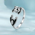 Adjustable sterling silver panda ring bracelet with white gold plating on a wrist.
