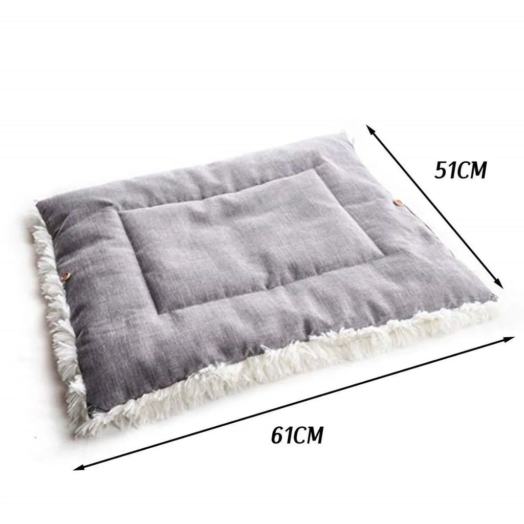 Two purpose gray pet blanket nest with long plush top and black non-slip bottom on a sofa