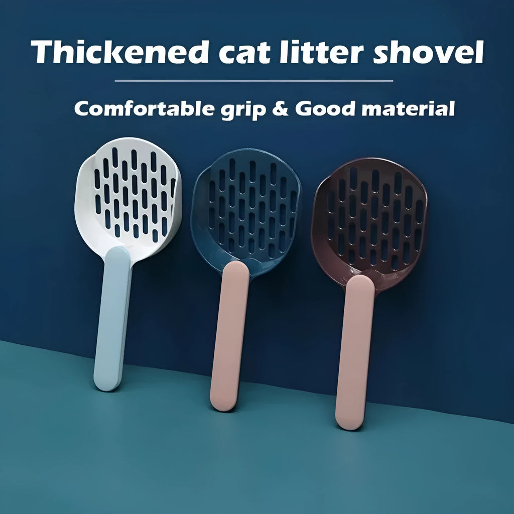 Plastic cat litter shovel in blue, green, and pink colours on a clean surface