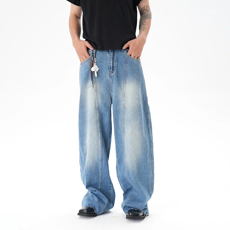Light blue wide leg machete jeans with vintage washed denim finish, zip-fly closure, cut wash effect