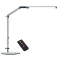 Black clip-on LED desk lamp with remote control attached to a desk edge, showing its folding arm.