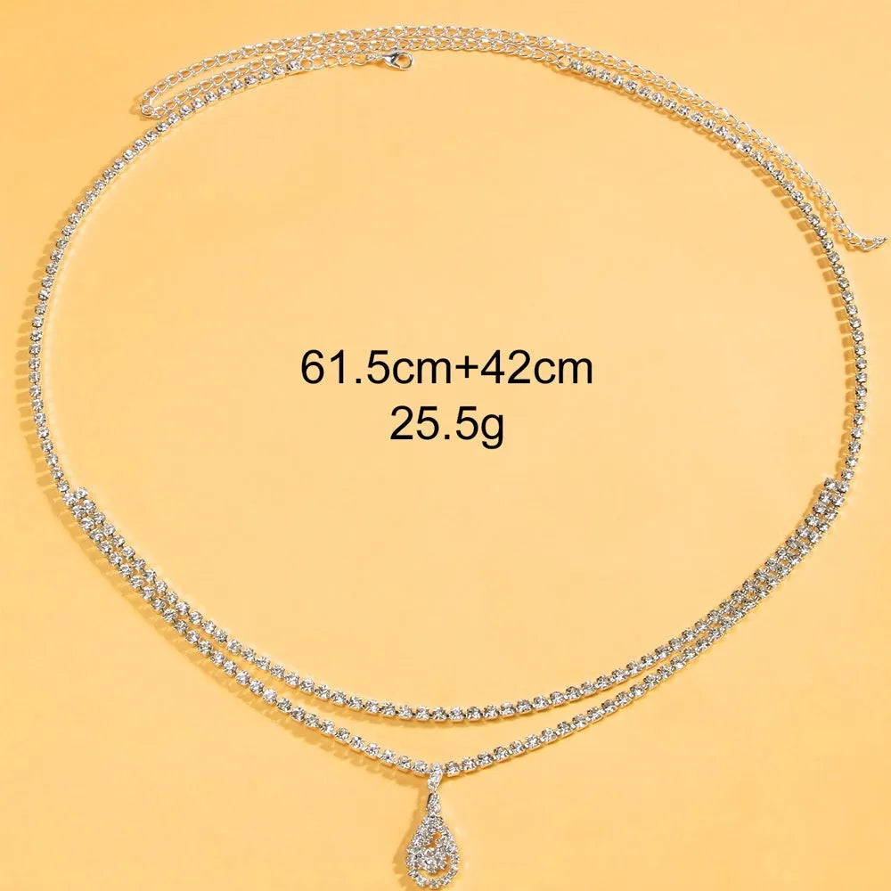 Gold water drop pendant waist chain with sparkling rhinestone tassel and lobster buckle.