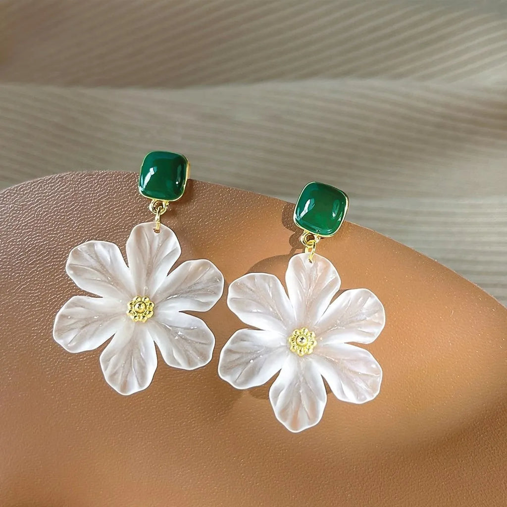 A pair of dark green alloy earrings with a sweet needle flower design on a white background.