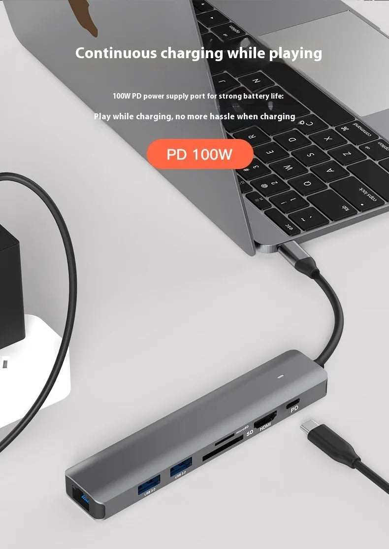 Silver aluminium USB C 7-in-1 hub with HDMI, USB 3.0 ports, and SD card slots.