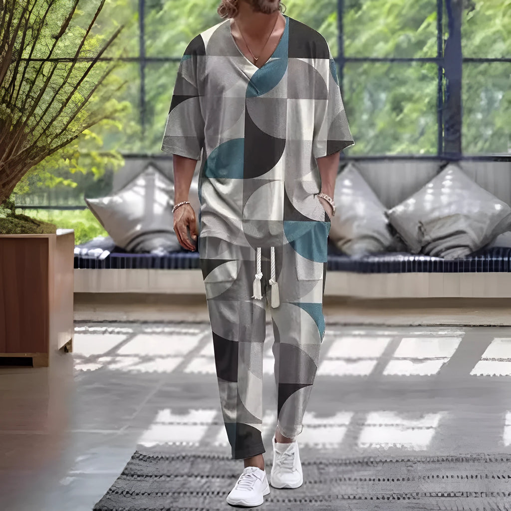 Man wearing a thin V-neck cropped sleeve jacket and matching trousers from the polyester suit set.