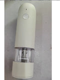 Rechargeable electric pepper and salt grinder set with clear acrylic body, LED light, and USB cable on a countertop