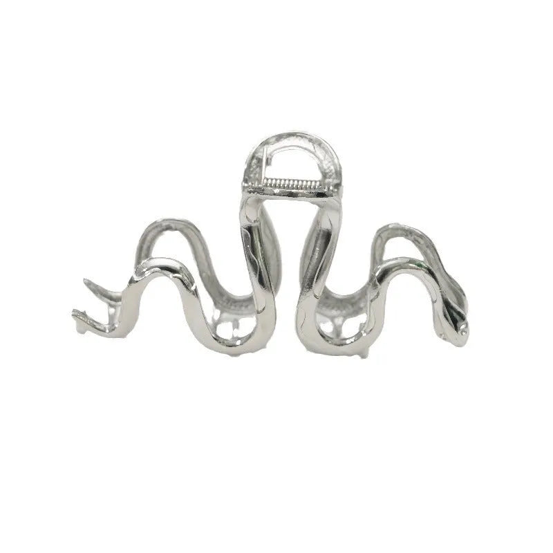 Slytherin serpentine metal hair clip in silver, 10.5cm, on flat surface