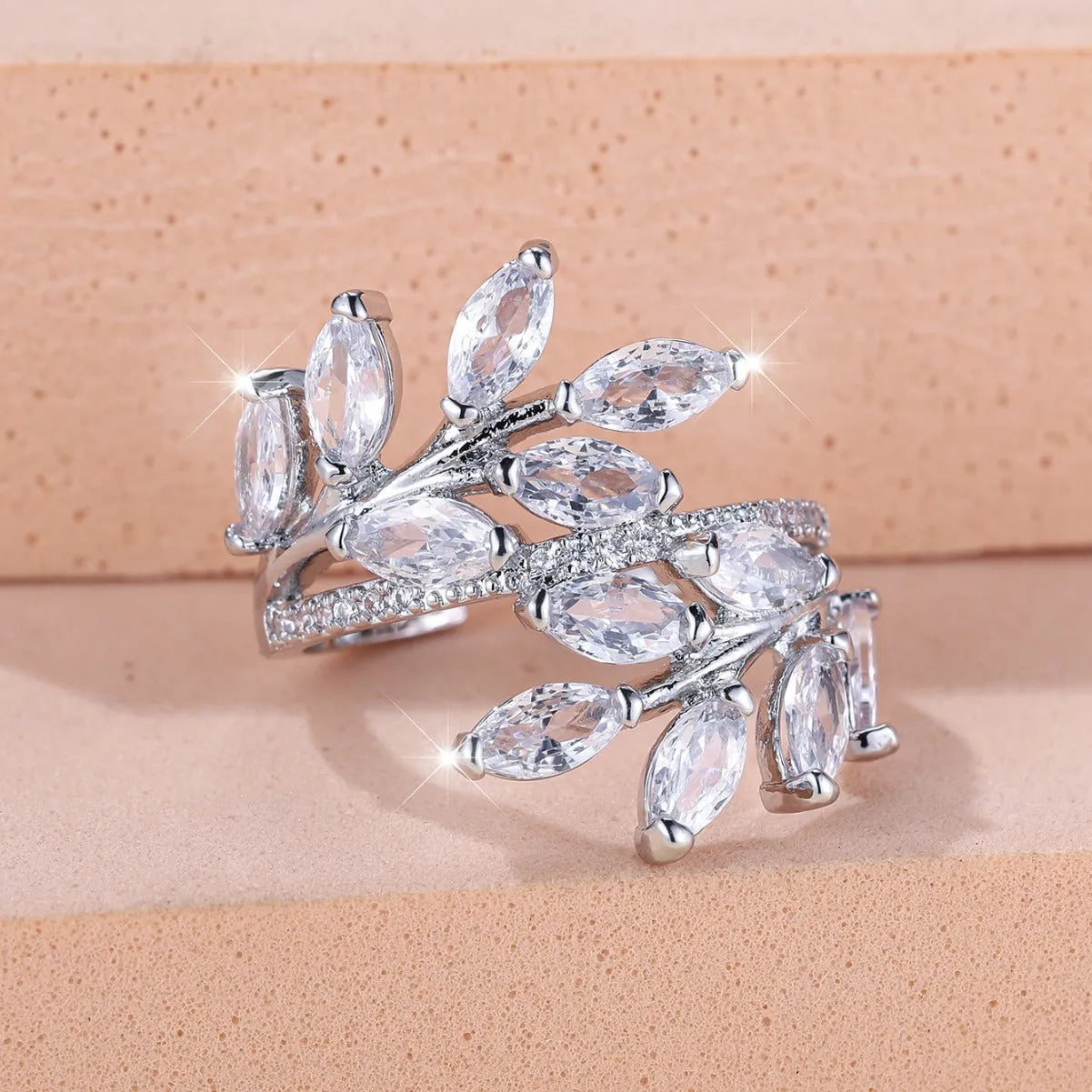 Adjustable copper leaf ring with zircon stones in various colour settings including platinum and rose gold options