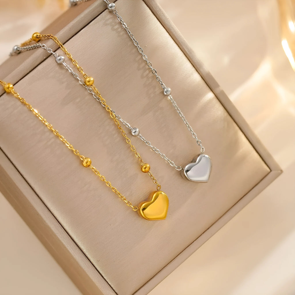 Women's titanium steel necklace with geometric pendant and ball bead chain in silver finish on white background