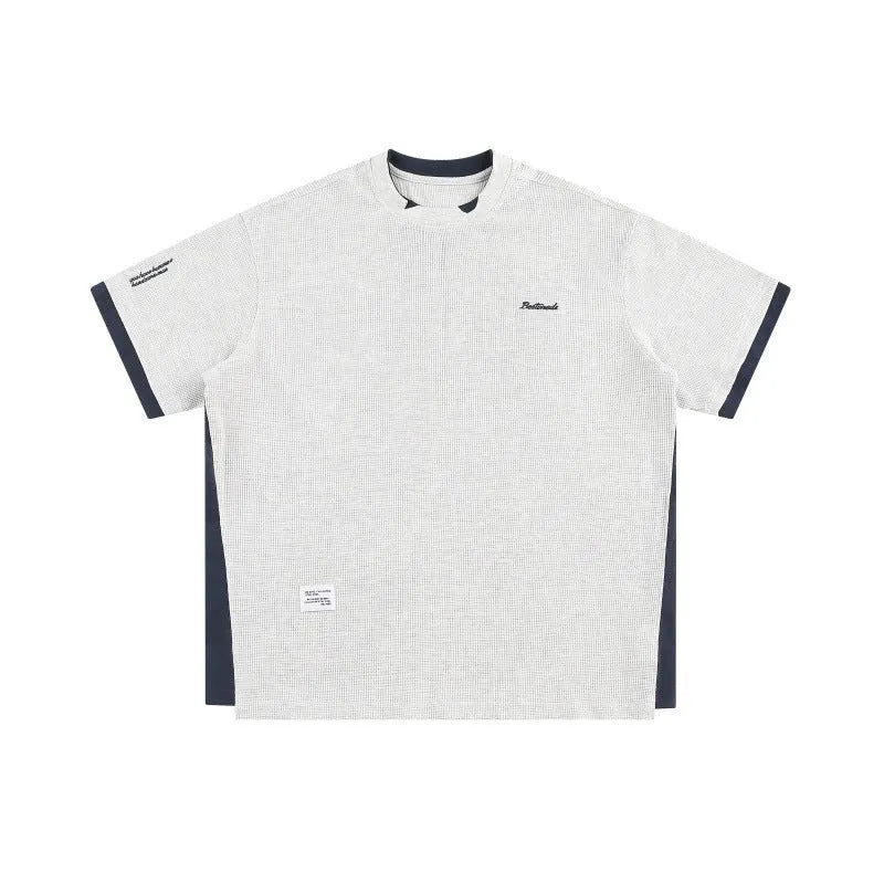 Retro alphabet embroidered loose waffle short-sleeved t-shirt in navy blue on a hanger.