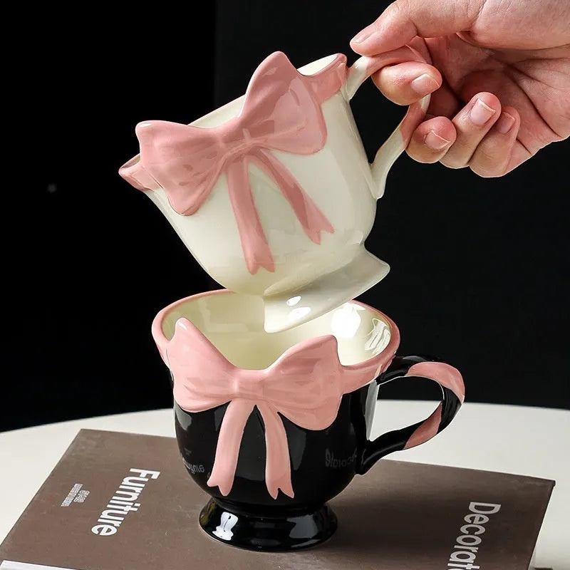 Ceramic mug with heart bow design in white powder or black pink colours, 301-400ml capacity