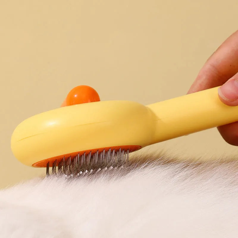 Small yellow duck pet grooming comb with fine needles and open section hair collection design