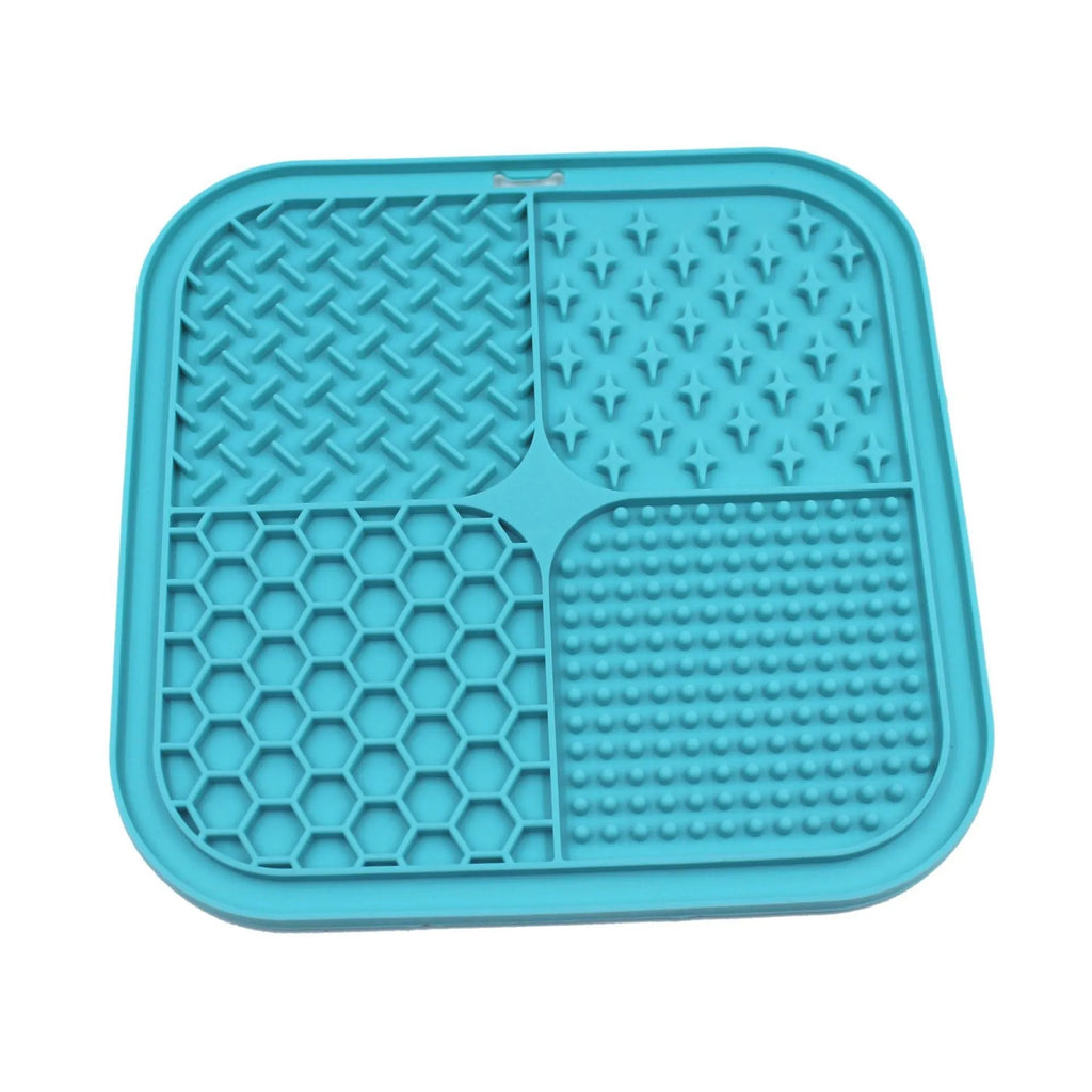 Green silicone pet licking pad 20x20cm with suction cup base on a tiled floor