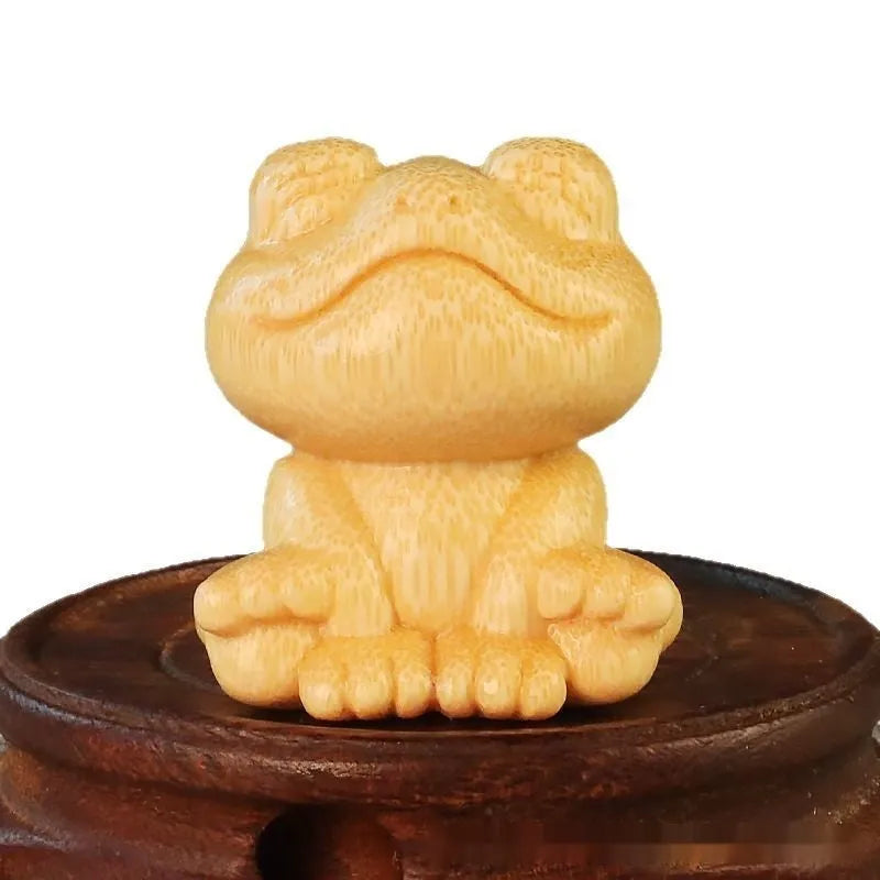 Solid bamboo smiling frog cartoon ornament measuring 5cm tall.