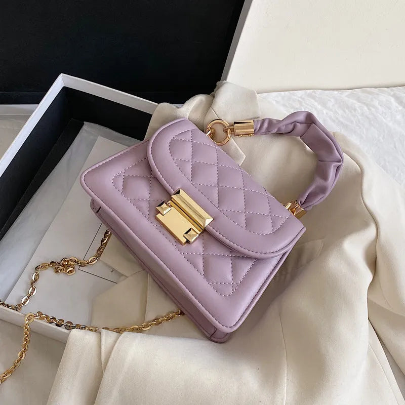 Purple women's small square shoulder bag with crossbody strap showing tapered 16x19cm design