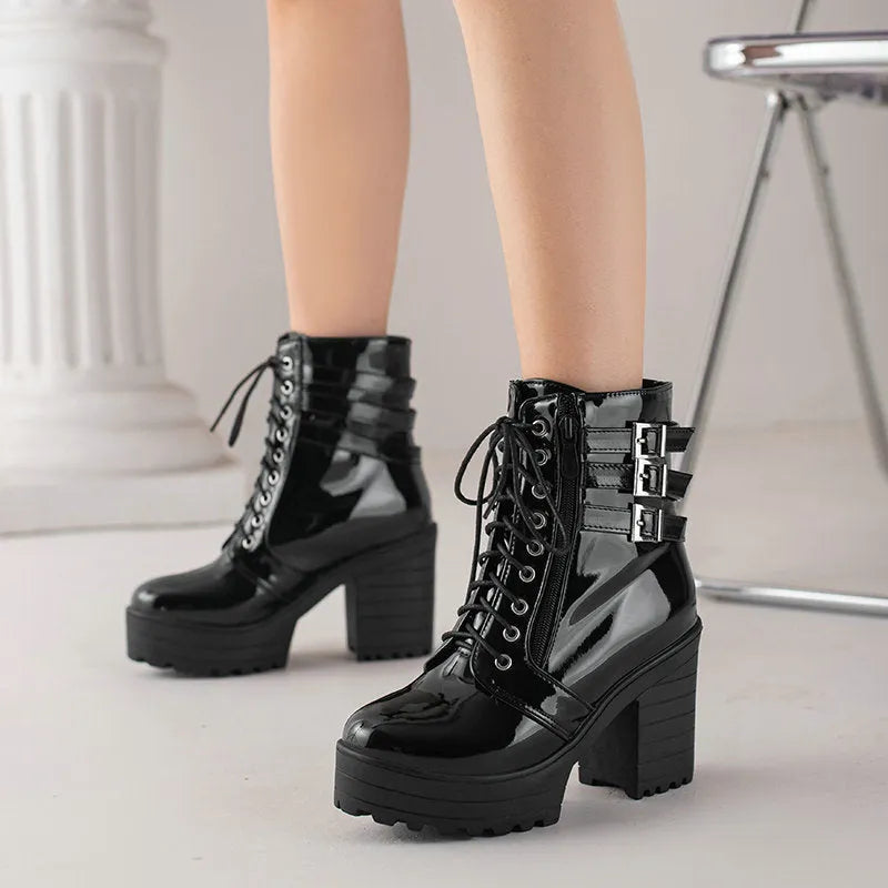 Women's black thick-heeled short boots with lace-up front and round toe, showing waterproof platform detail